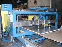 Here, the flying cutoff saw has clamped the foam board and is half way through a cut. Click to enlarge.