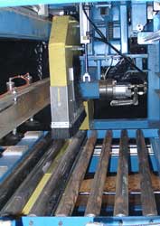 Inside the yellow dust shroud is the saw blade of the flying cutoff saw. Click to enlarge.
