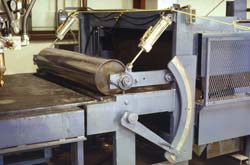 The upper roller is vertically adjustable prior to production, while the lower plate is adjustable vertically for fine adjustments during production. Click to enlarge.