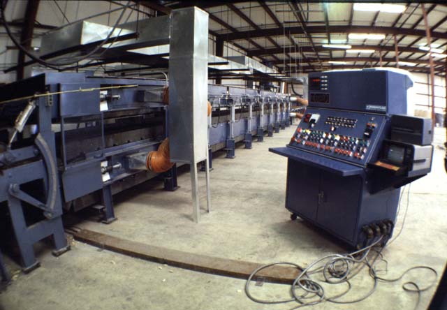 Shown here is the front of the Foamboarder and the main control console, where one person can run the entire line.