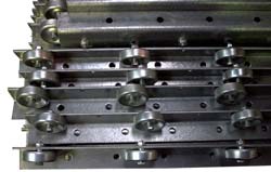 A group of pallet rail guides. Pallet rail guides help the pallet maintain a center position as it glides down Palletflo gravity flow rails.