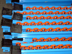 There are three types of Palletflo rails: entry, intermediate, and discharge. These are discharge rails with rail stops.