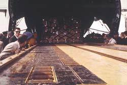 The 40K is transferring the pallet using its powered conveyor system.