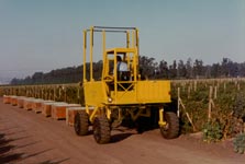 Straddle Fork quickly picks up full bin and easily drives over empty or partially full bins.