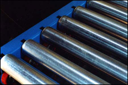 The roller sits in a slot that allows it to move up and down while compressing the Palletflo tire.